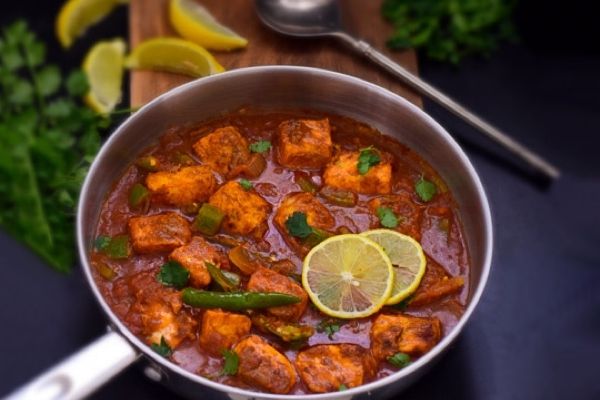 Salmon Jalfrezi, indian dish in a silver pan