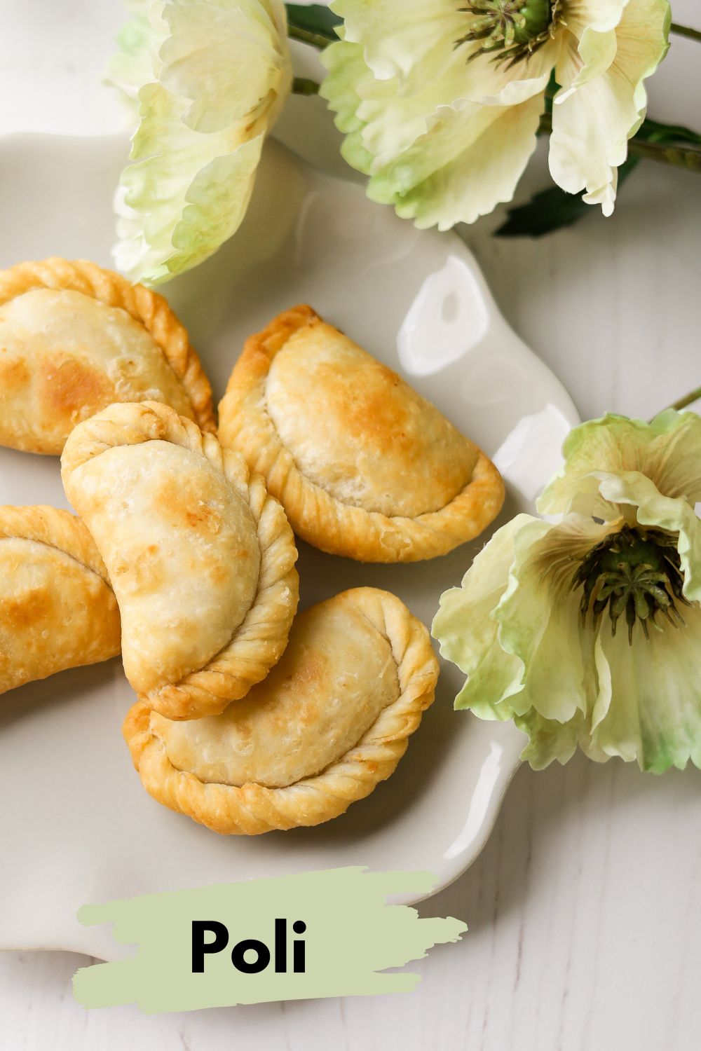 Flaky Poli in a beige plate with flowers on the righ