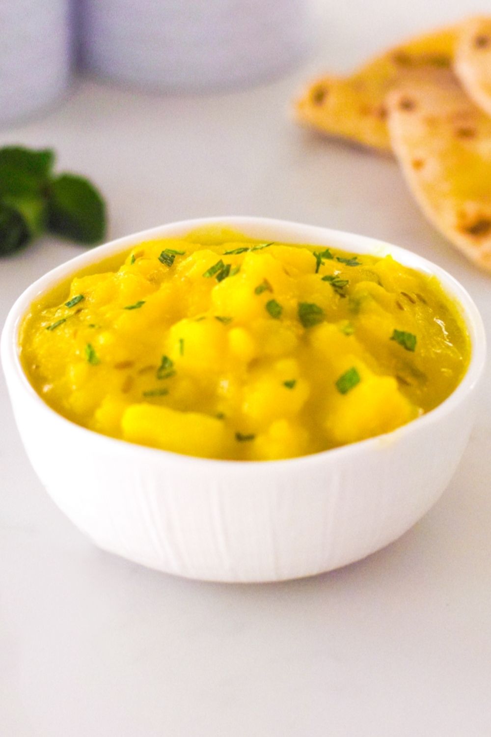Yellow Potato Curry in a white bowl