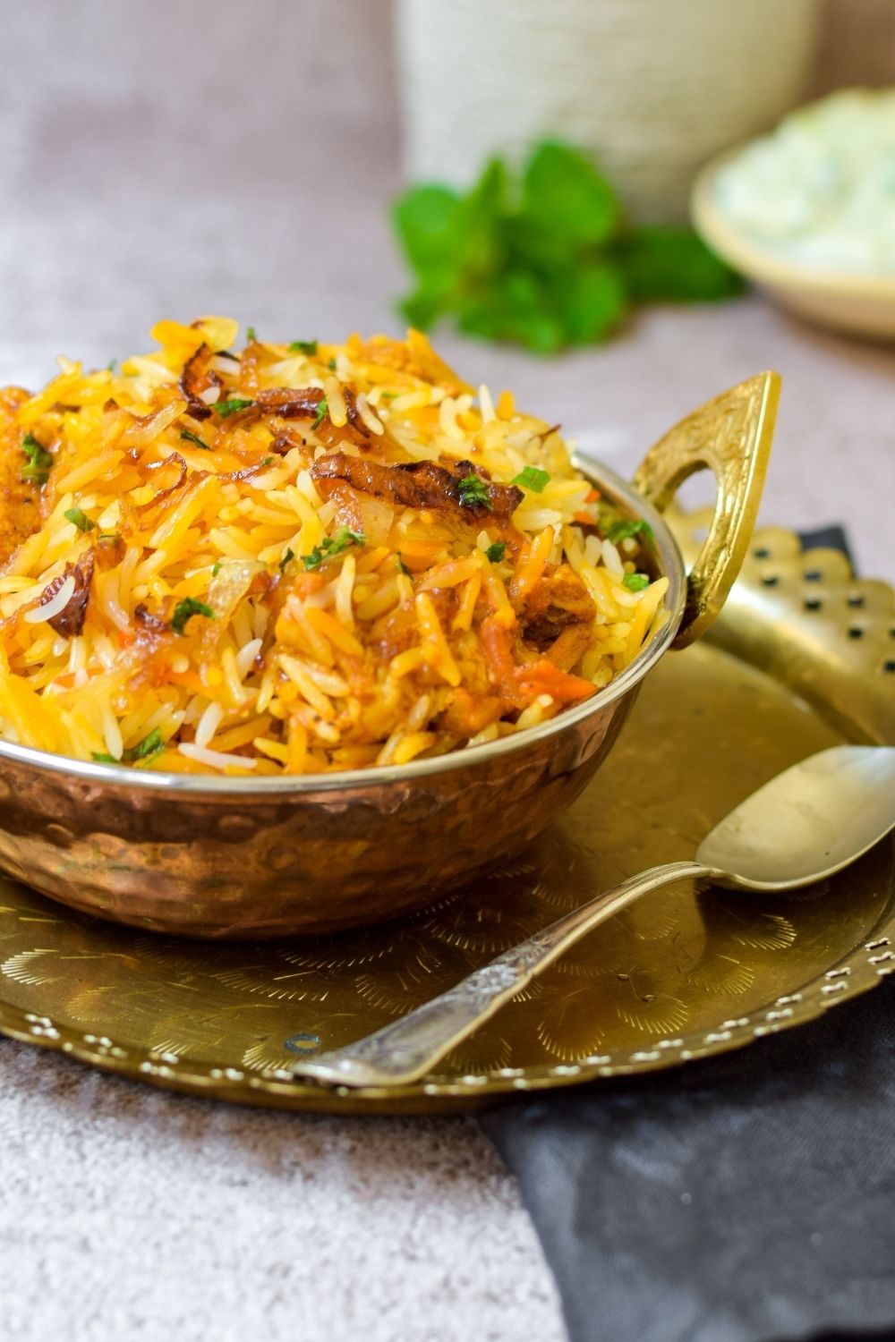 Spicy Butter Chicken Biryani in a copper bowl