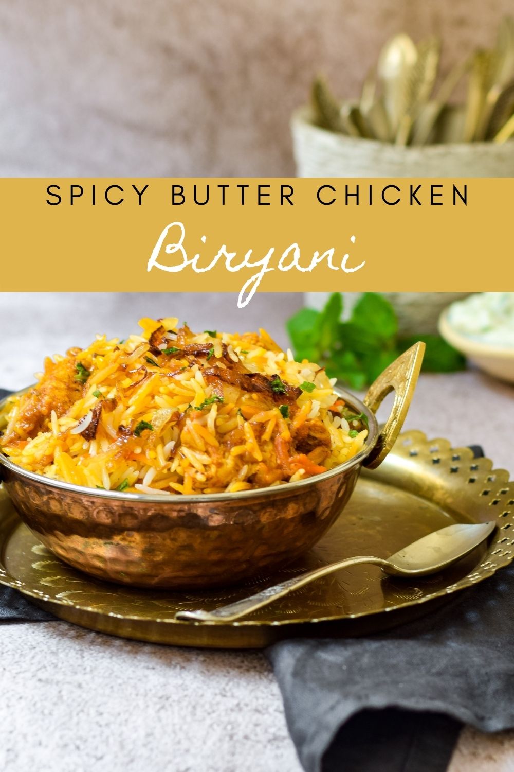 Spicy Butter Chicken Biryani in a copper dish