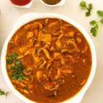 Mushroom curry cooked with tomatoes, yogurt and spices