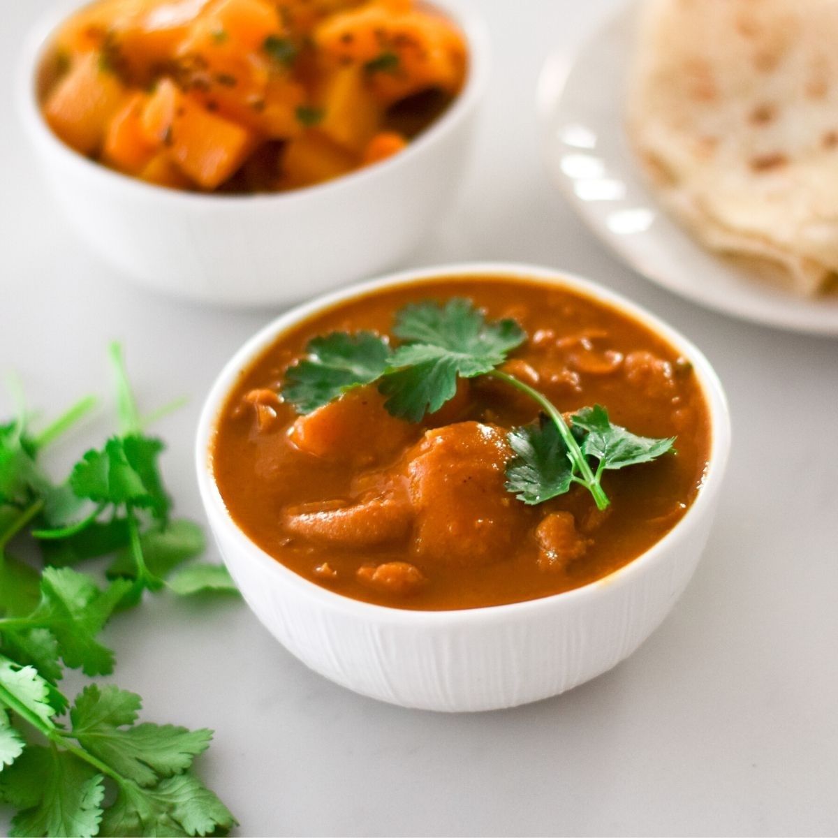 Red Speckled Bean Curry in a white bowl