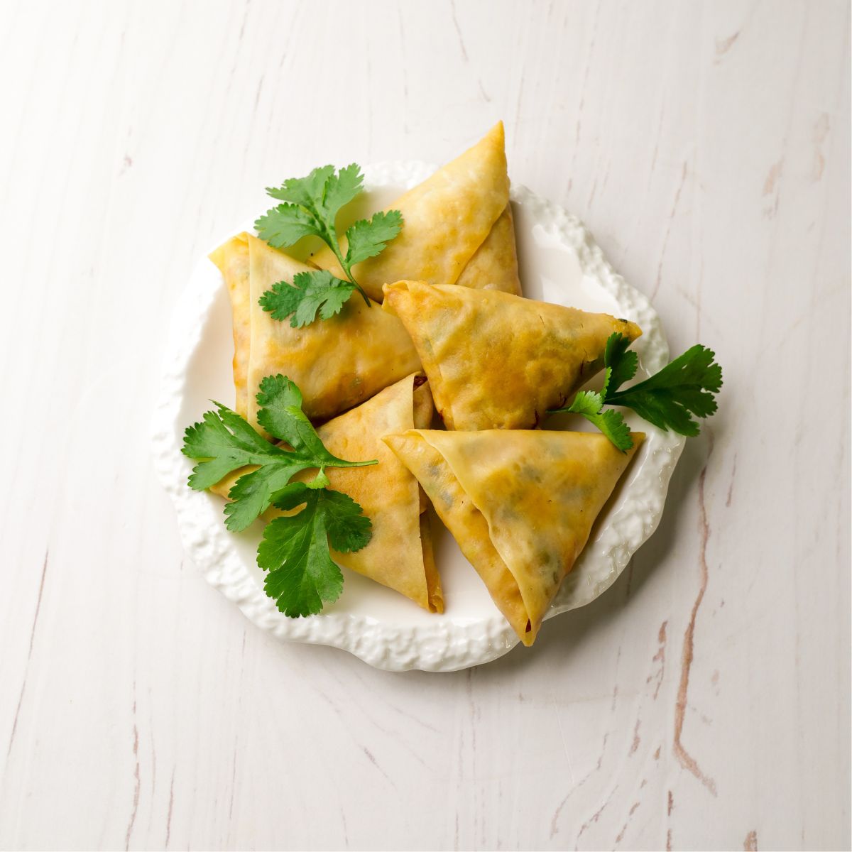 Sweetcorn & Cheese Samoosas in a white plate