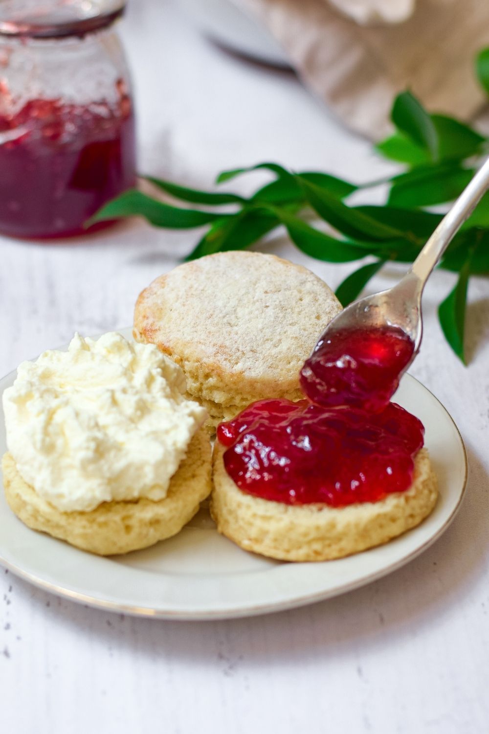 Soft scones with Buttermilk in a white plate with jam and cream