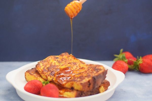 French Toast made with Panettone Bread and served with a drizzle of maple syrup
