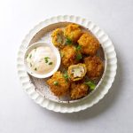Egg-Free crumbed mushrooms in a white plate with a dip