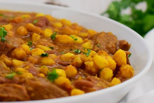 Samp and Beans with Lamb in a white bowl