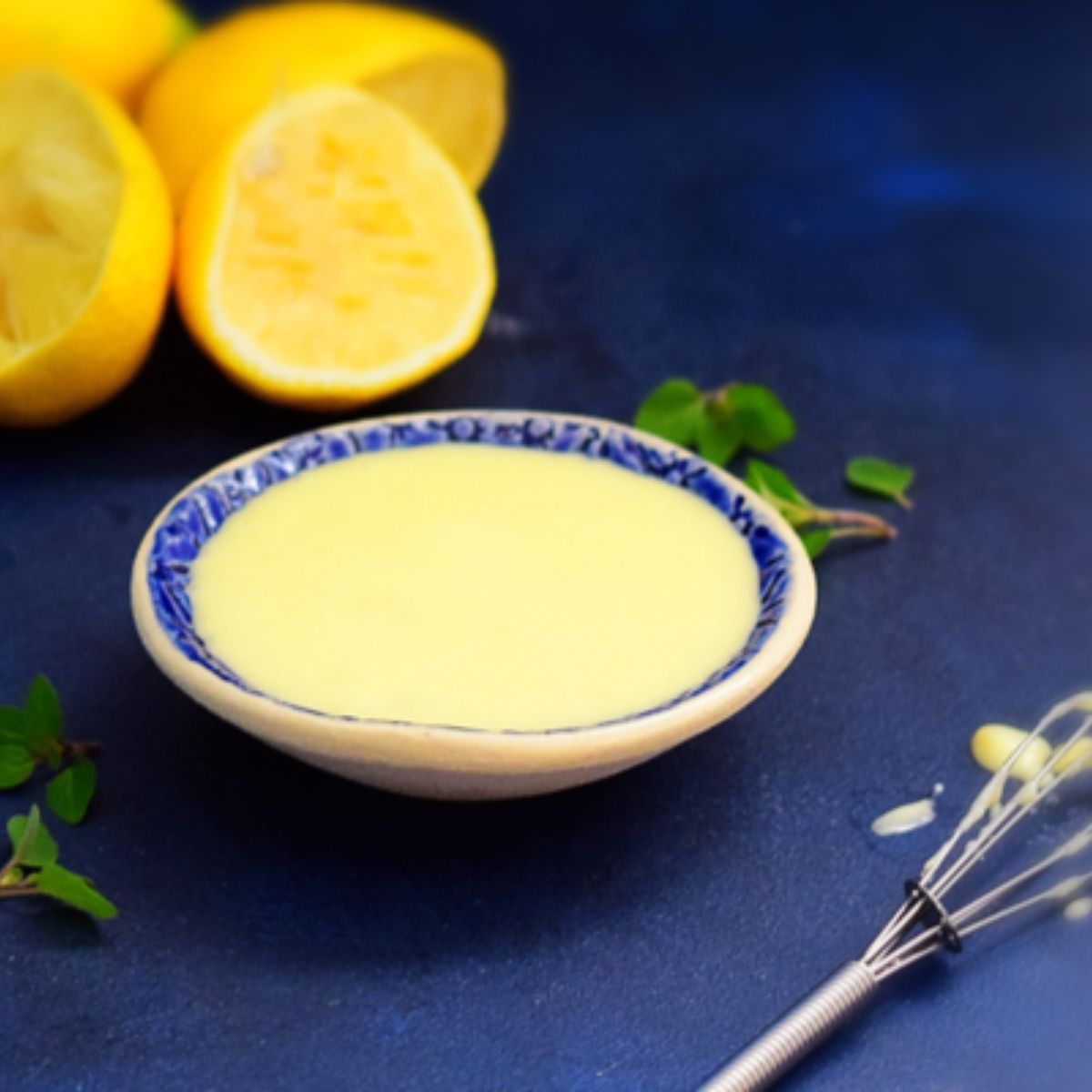 Creamy lemon butter sauce in a blue bowl
