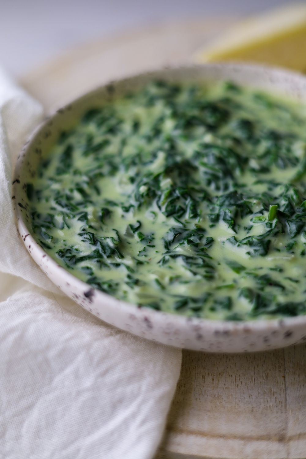 Creamed spinach in a white bowl