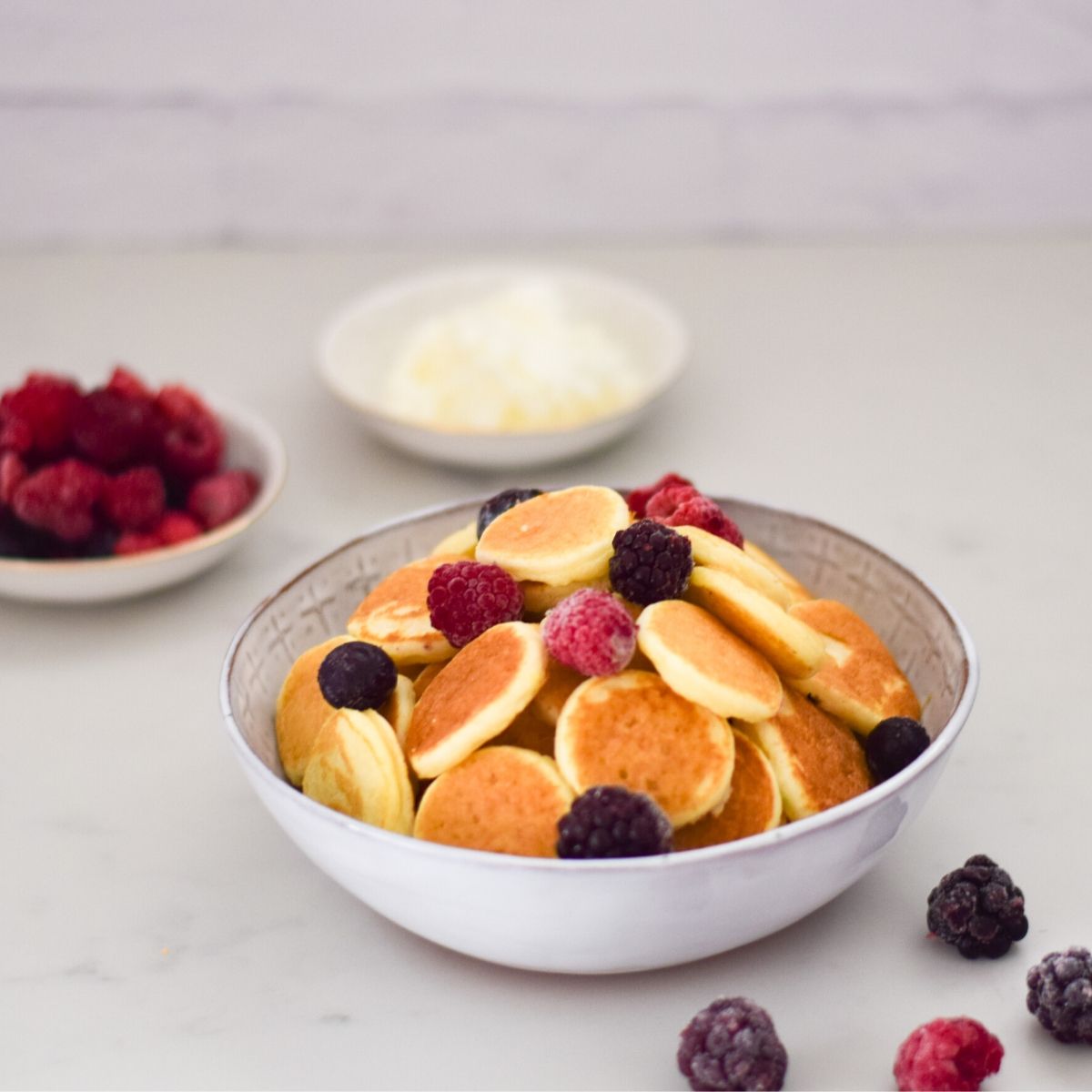 Cereal Pancakes in a white bowl topped with berries