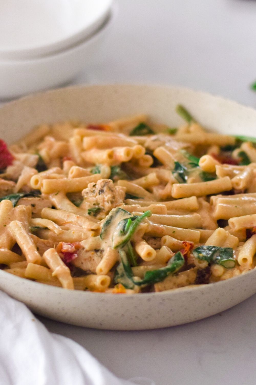 creamy sundried tomato pasta in a white pan