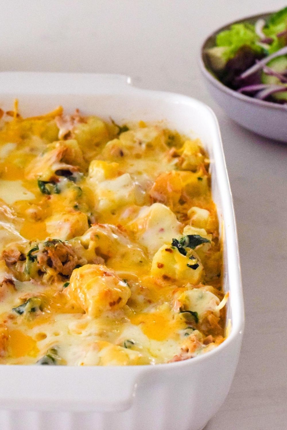 Tuna Potato Spinach Bake in a white oven dish