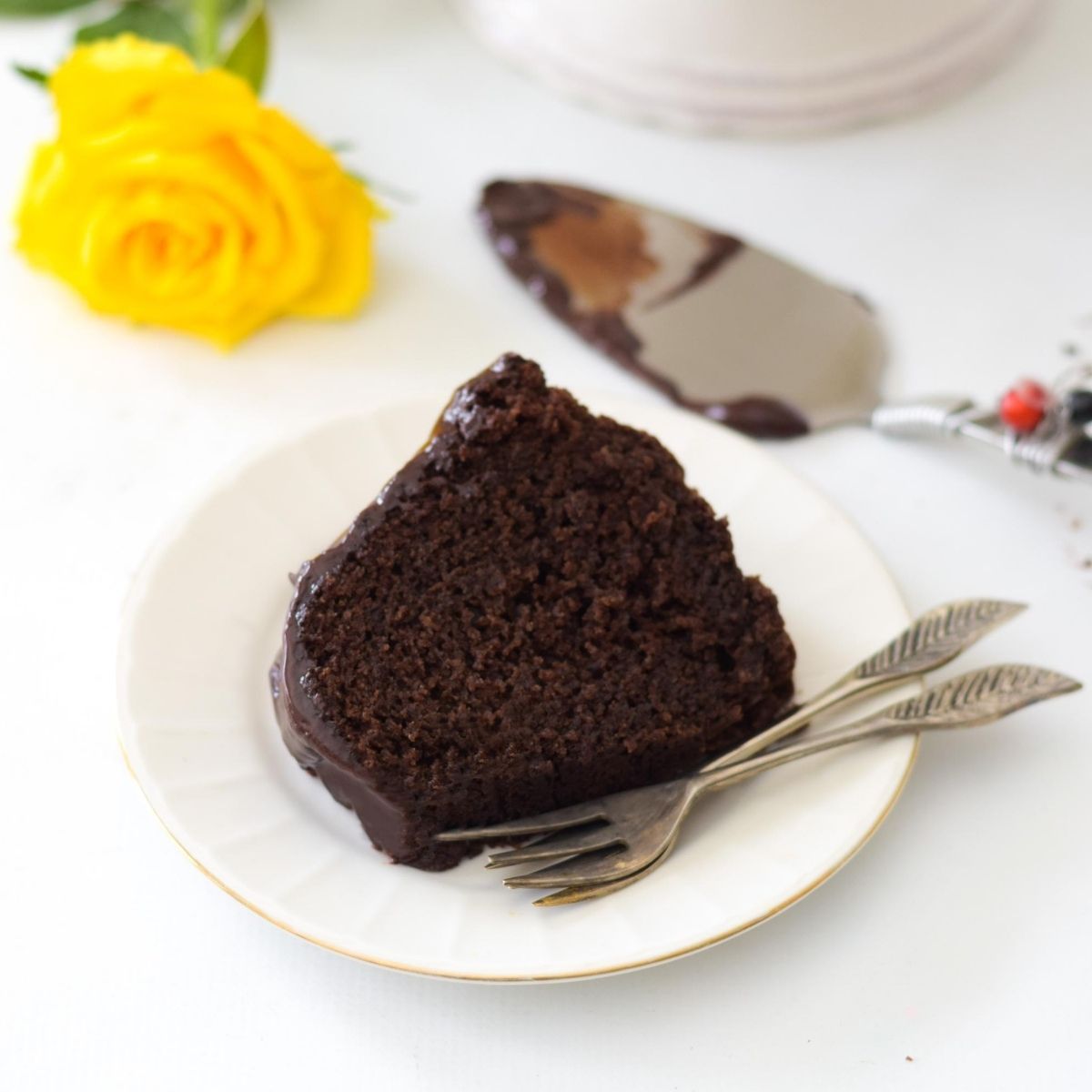 chocolate bundt cake on a white plate with forks