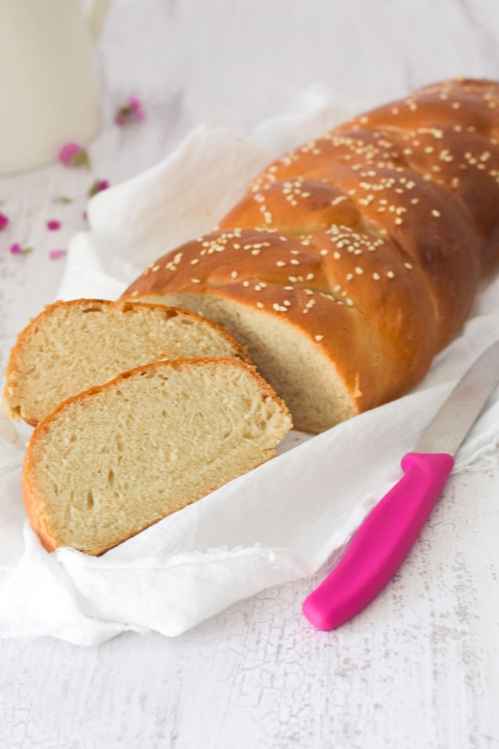 Braided Bread on a white cloth with a pink knife on the side