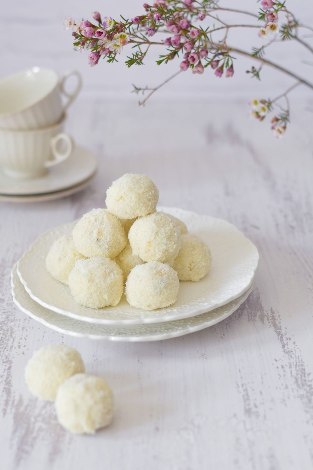 Nutty Chocolate Coconut Cookies on a white plate with flowers on top