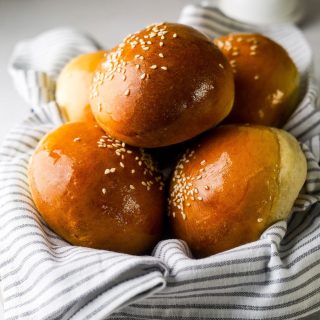 Brioche Buns in a dish with a kitchen towel