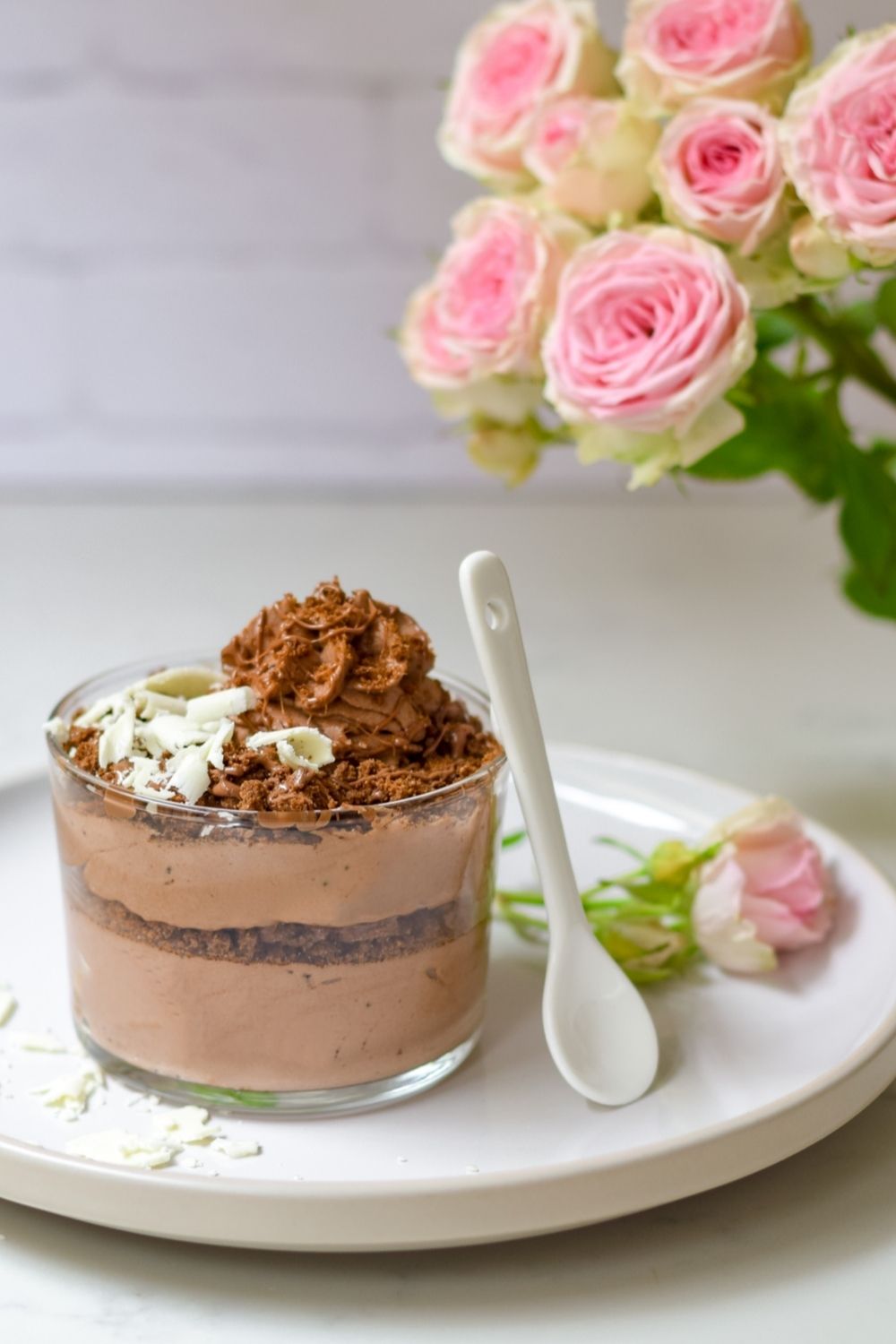 Chocolate Mousse with Romany Creams in a glass on a white plate