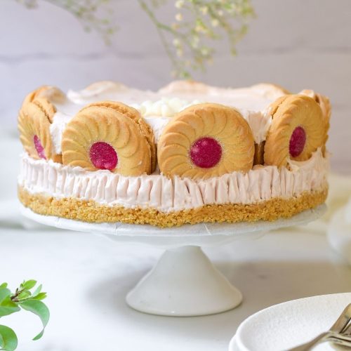 Strawberry Whirl Cheesecake on a white cake stand