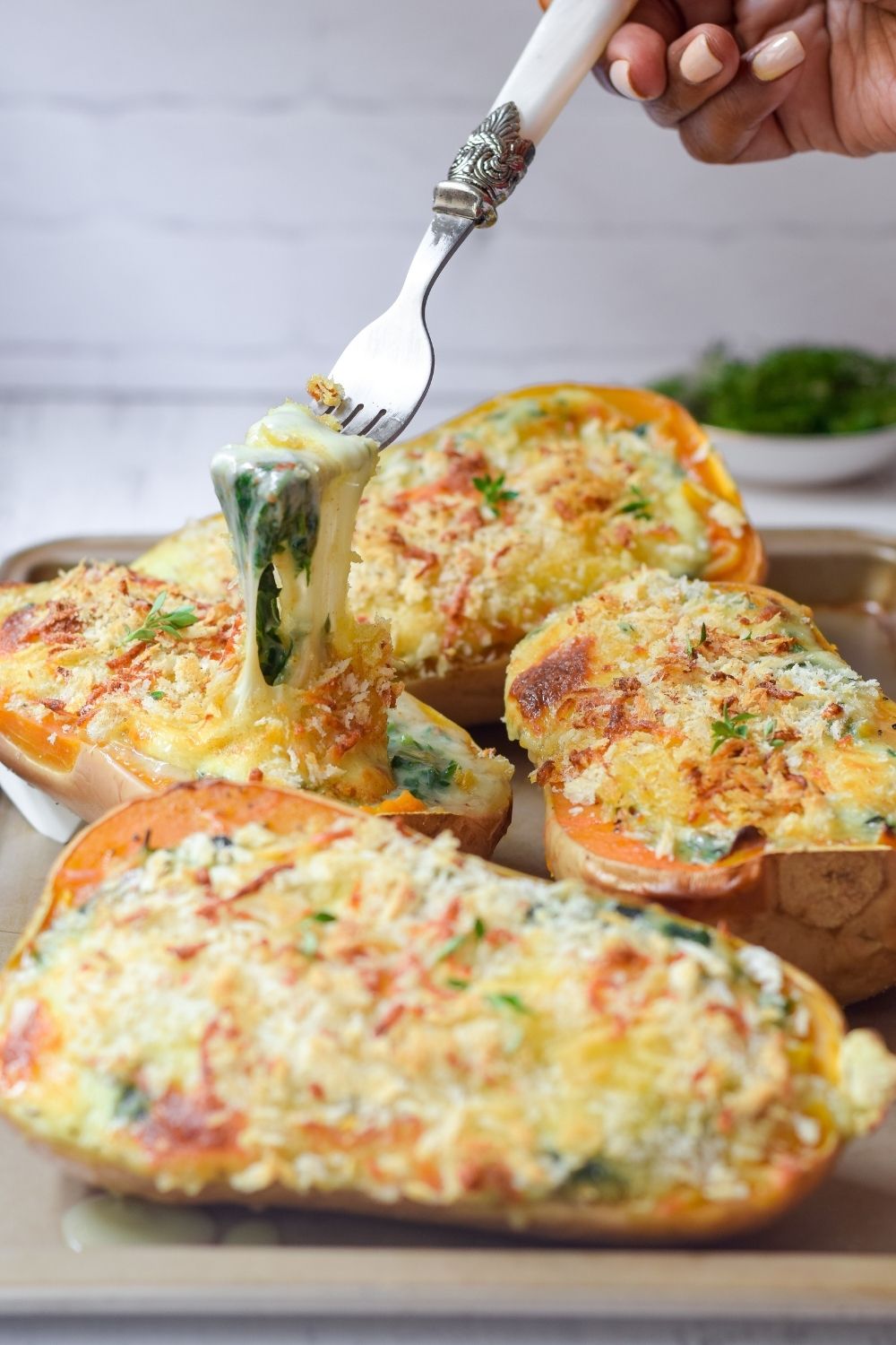 Creamed Spinach stuffed butternut on a baking tray