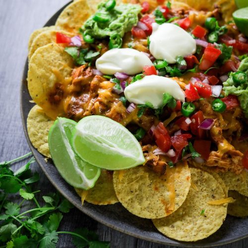 Spicy Chicken Nachos in a black plate