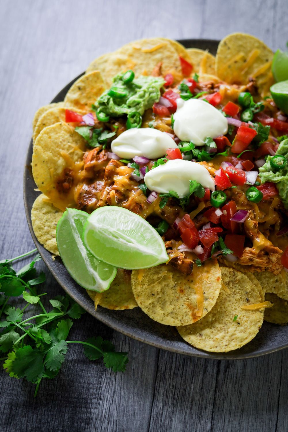 Spicy Chicken Nachos in a black plate