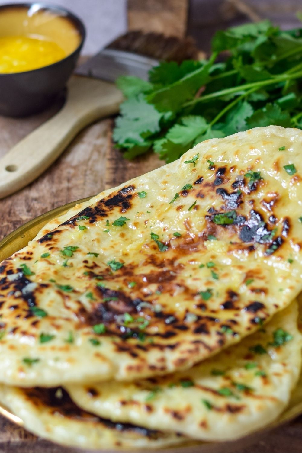 Cheesy Garlic Naan Bread on a wooden board