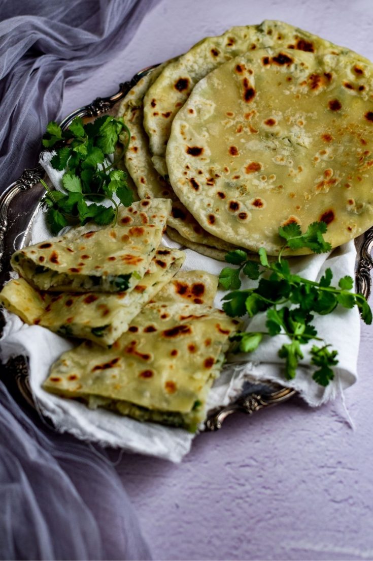 Aloo Paratha on a white cloth in a tray