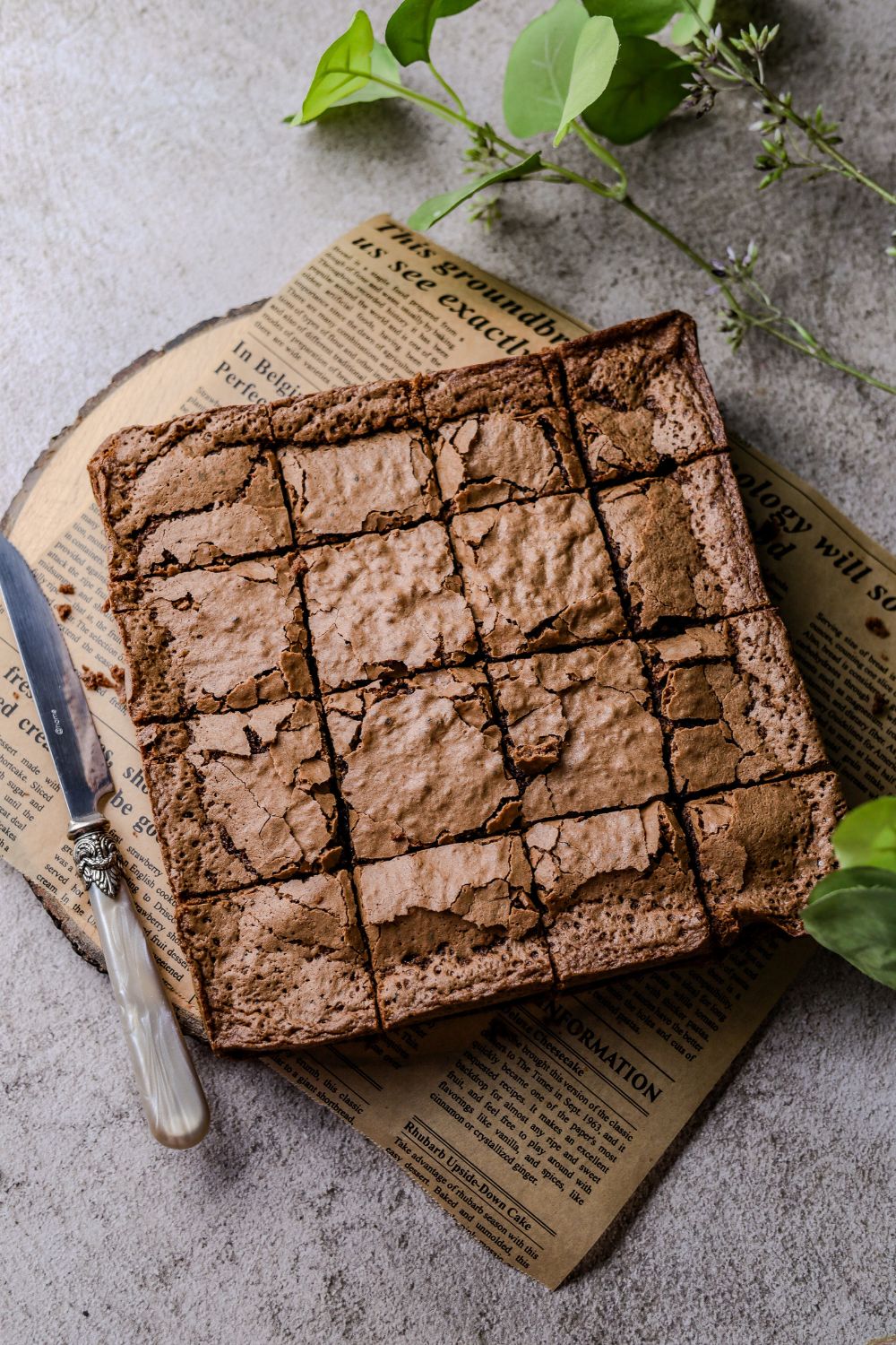 Easy Chocolate Brownies on a piece of brown paper on a wooden board