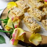 Hungarian Tart on a brown cheese board with roses on the bottom left