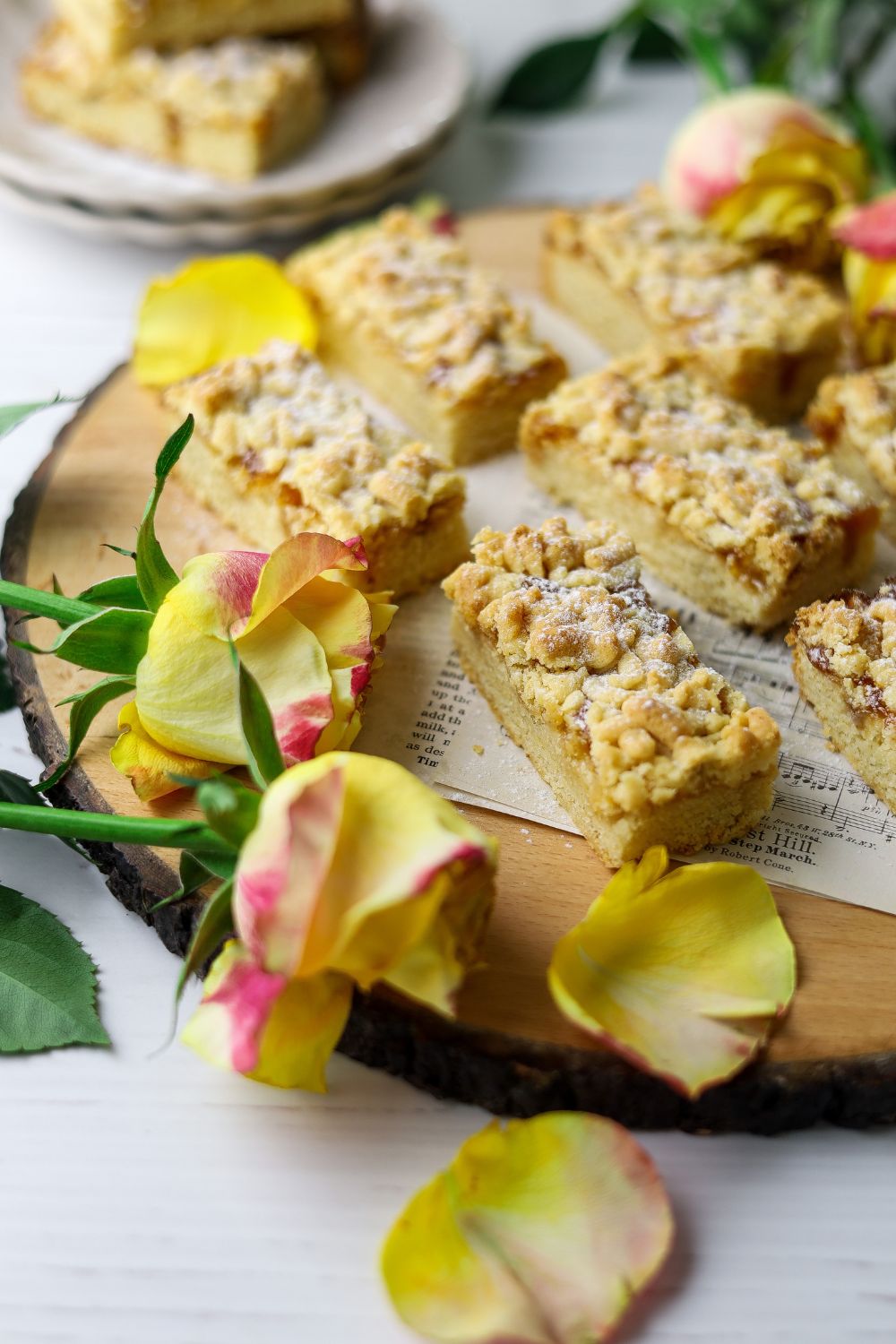Hungarian Tart on a brown cheese board with roses on the bottom left