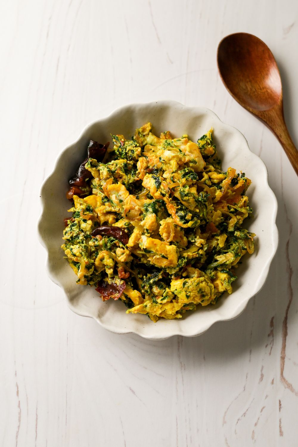 Methi and Eggs in a white bowl