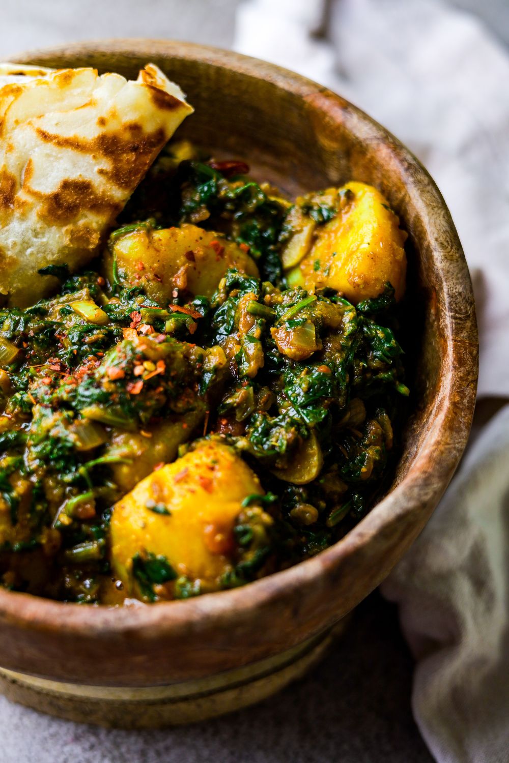 Saag Aloo in a brown wooden bowl