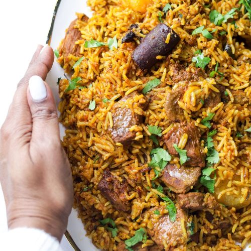 Lamb Akni in a white platter