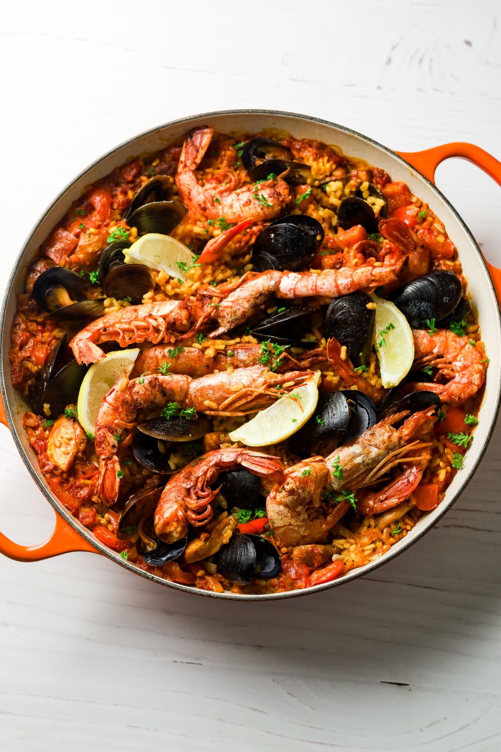 Paella in an orange and white pot
